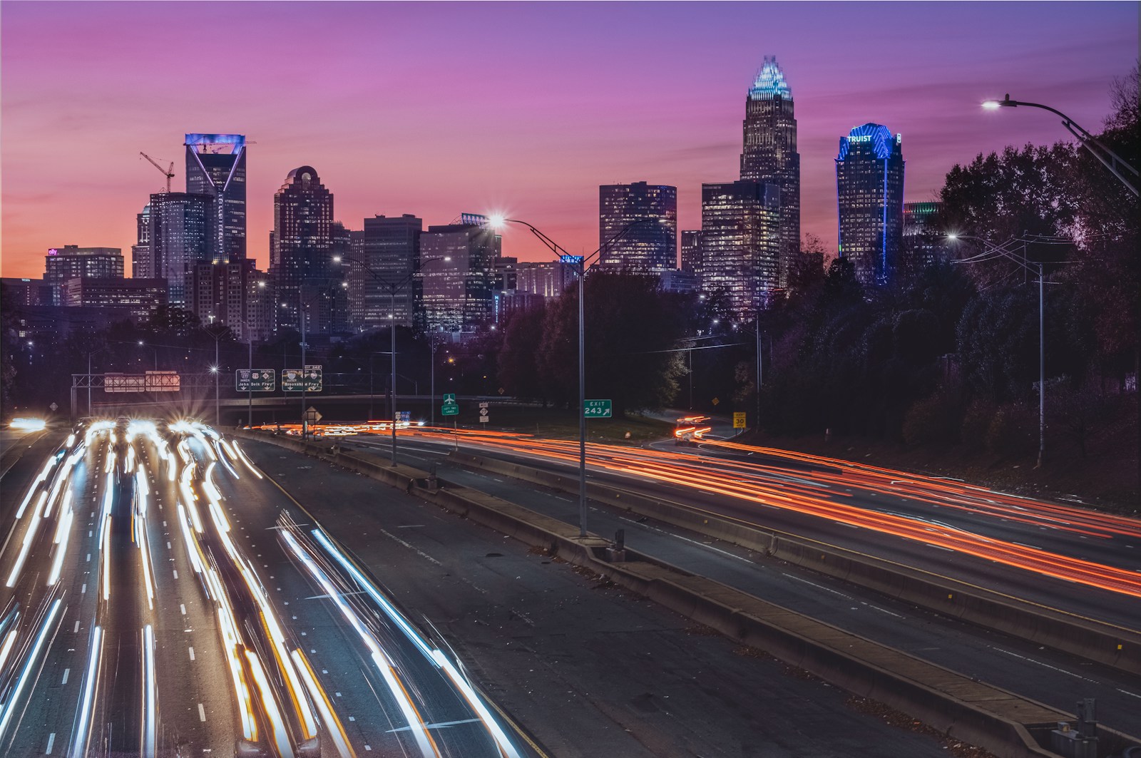 a city skyline at night with a lot of traffic